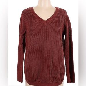 R D Style Burnt orange V neck sweater with a relaxed fit curved hem